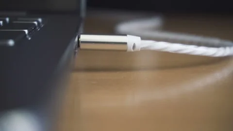 Man hand disconecting headphones cable, audio jack insert. Close up shot Stock Footage 87775874
