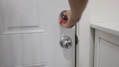 Man hand with door handle and lock Stock Footage 310859534