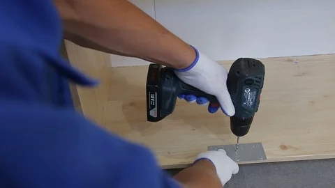 Man hand drilling a hole during furniture assembling. Close up. Video stock 122855062