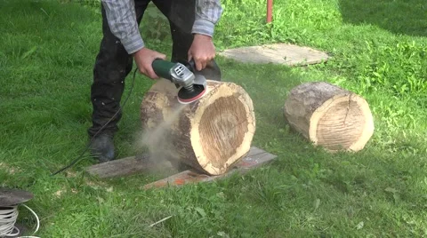 Man hand with electric sander tool sand wood oak tree log. Closeup. 4K Stock Footage 58671009