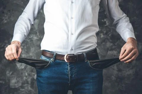 Man hand empty pocket on dark background Stock Photos