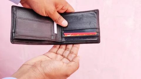 Man hand an empty wallet on light background Stock Photos