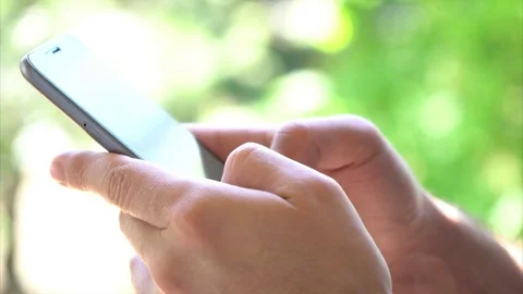 Man hand fingers touch smartphone screen outdoor Stock Footage 76323626