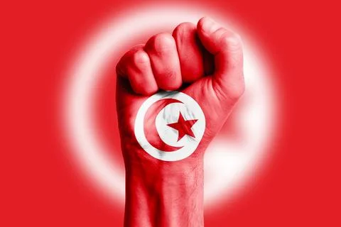 Man hand fist of TUNISIA flag painted. Close-up. Stock Photos