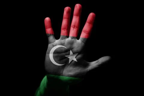 Man hand with flag of Libya in stop sign Stock Photos