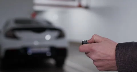 Man hand on foreground unlocking parked car with key 스톡 동영상 170153613