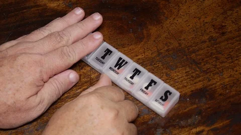 Man hand gets pill out of  pill box. Video stock 70204097