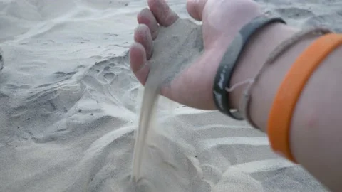 Man hand goes through sand and picks up a handful of sand and lets it drop 스톡 동영상 132172279