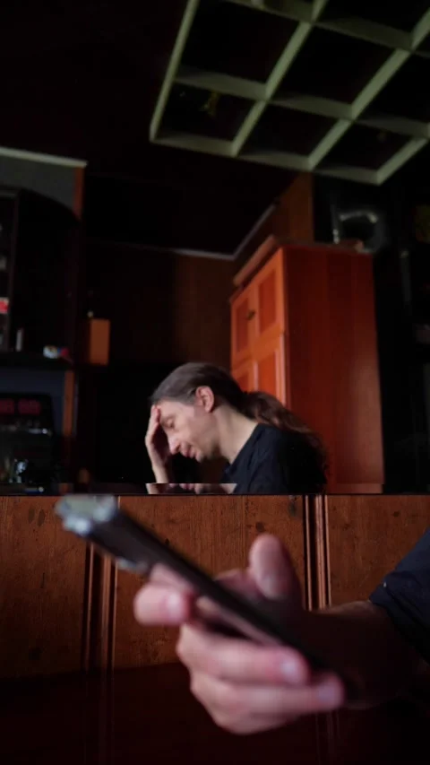 Man with Hand on Head, Distraught, with Foreground Phone 스톡 동영상 311013502