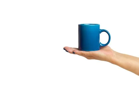 Man hand holding a blue mug on a white background with copy space Stock Photos