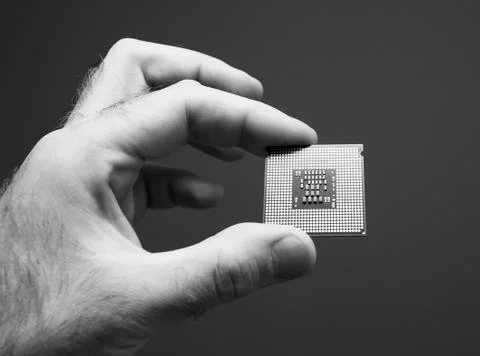 Man hand holding CPU Central processing unit gray background 스톡 사진