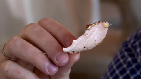 Man hand holding a crispy chip Stock Footage 72287780