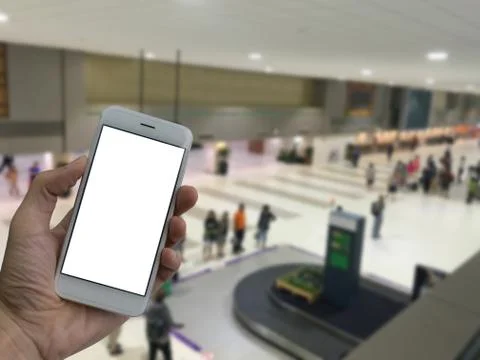 A man hand holding empty screen of smart phone and blur the airport waiting f Stock Photos