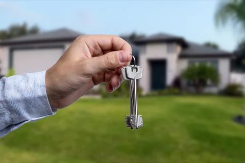 Man hand holding on finger keys to new house. Stock Photos