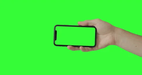 Man hand holding the iPhone 11 on green screen chroma key background.  Video stock 131262307