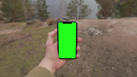 Man hand holding iPhone 11 in vertical or portrait orientation. Green Screen Stock-Footage 151639906