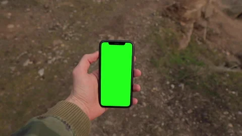 Man hand holding iPhone 11 in vertical or portrait orientation. Green Screen Stock Footage 151639975