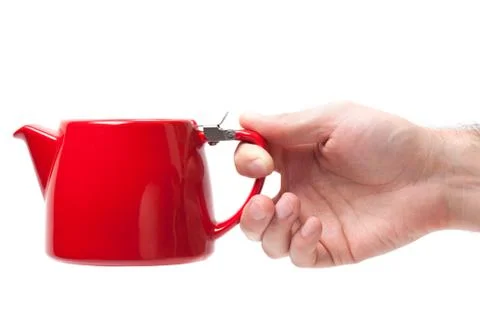 Man hand holding object Red teapot isolated on white background Stock Photos