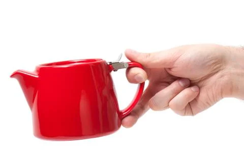Man hand holding object Red teapot isolated on white background Stock Photos