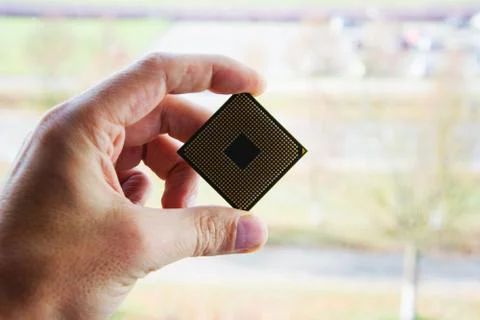 Man hand holding processor or computer CPU chip Stock Photos