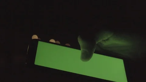 Man hand holding smartphone in night city, chroma key screen Stock Footage