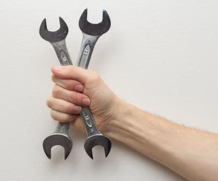 Man hand holding wrenches Stock Photos