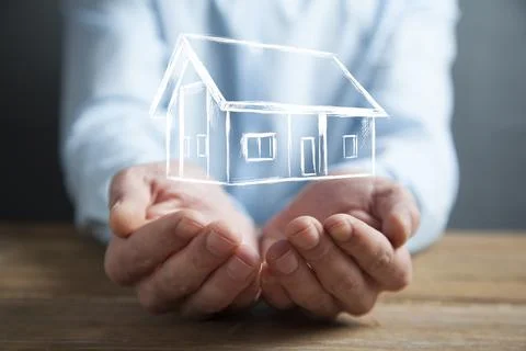 Man hand house model in screen Stock Photos