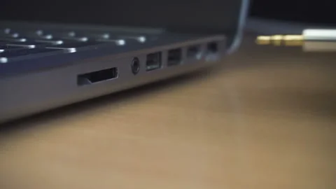 Man hand inserting headphones cable into audio jack insert. Close up shot Stock Footage 87775808