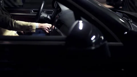 Man hand in a jacket drives a key with an expensive luxury car Stock Footage 91829205