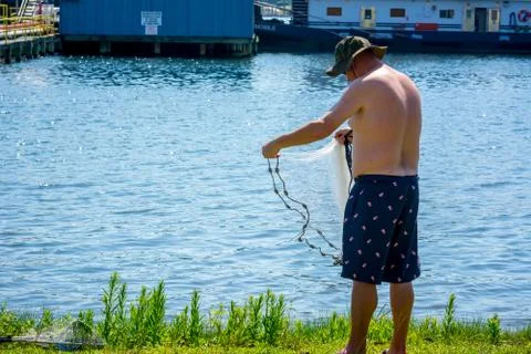 Man that Hand Launches the Fishnet at Sea Stock Photos