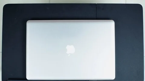 Man hand opening Apple Macbook Pro computer and power up to begin work Stock Footage 101816299