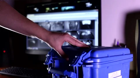 Man hand opening small blue high security level bulletproof case and taking tech Stock Footage 132675120