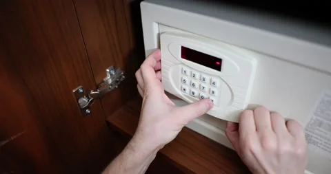 Man hand opens and closes safe hidden in closet in hotel Stock Footage 232618213