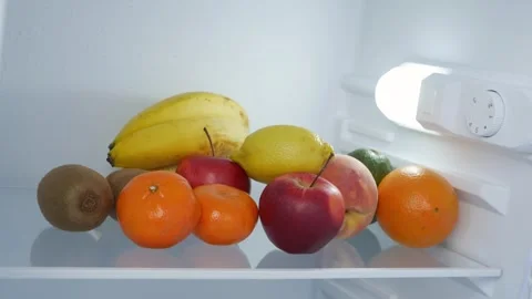 Man Hand Opens Kitchen Fridge Door Looking Inside for Fresh Food and Drink. Stock Footage 321247312