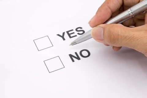 Man hand with pen over document, select Yes or No. Stock Photos