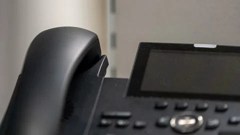 Man hand picking up a ringing office telephone/landline 動画素材 122055106