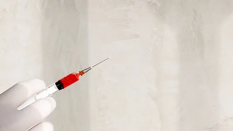 Man hand in plastic gloves with sirynge filled with blood Stock Footage 85545592