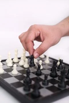 Man hand is playing chess Stock Photos