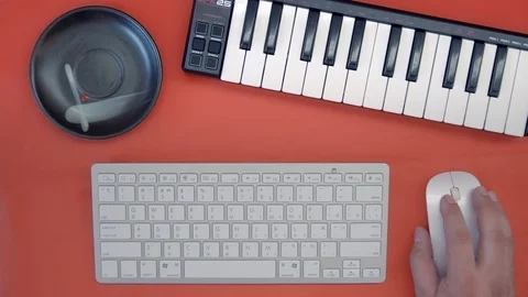 Man hand playing a MIDI controller keyboard synthesizer. DJ musician creates a Stock Footage 89351432