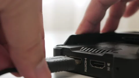Man hand plug and unplug HDMI cable into external monitor closeup. Stock Footage 157644730