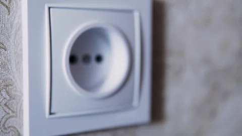 Man hand plug in charger adapter into wall socket close up Stock Footage 124440629