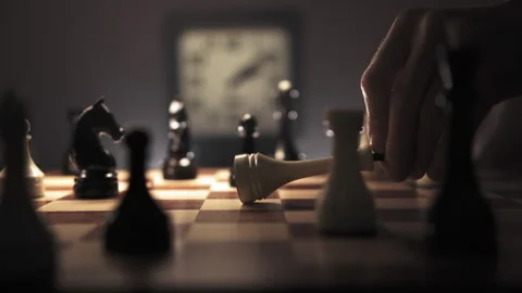 The man hand points white king on the board and then places it on the board Stock Footage 312816686