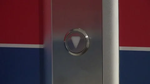 Man hand press the button and calls the elevator. It glows red then goes out Stock Footage 143856819