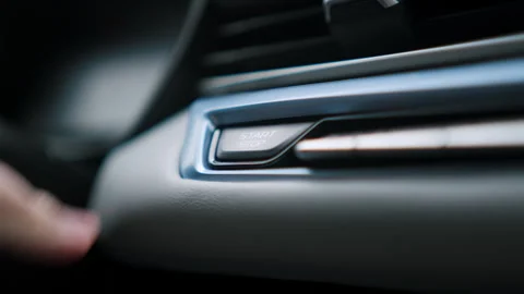 Man hand presses a rectangular engine start button in a modern car. Stock Footage 279108883