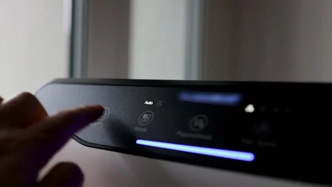 Man Hand Pressing Button on Smart Air Purifier Control Panel Stock Footage 339009905