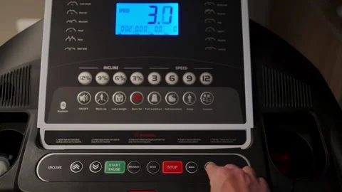 Man Hand Pressing Button on Treadmill Control Panel. Close-up of a person s.. Stock Footage 332335272