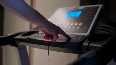 Man Hand Pressing Button on Treadmill Control Panel. Close-up of a person s.. Stock Footage 332335344