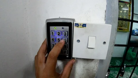 Man hand pressing door code to open the door Stock Footage 104444704