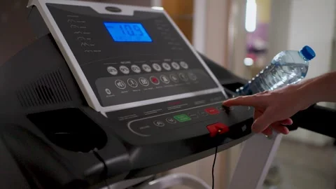 Man hand pressing start button on treadmill console in gym. Close-up of a p.. Stock Footage 332054760
