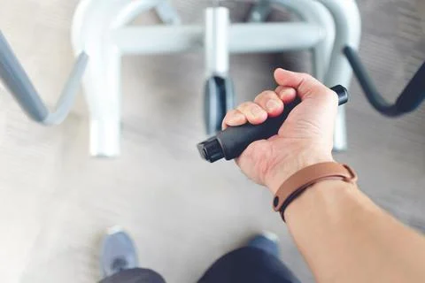 Man hand pull cable weight in a fitness gym. Stock Photos